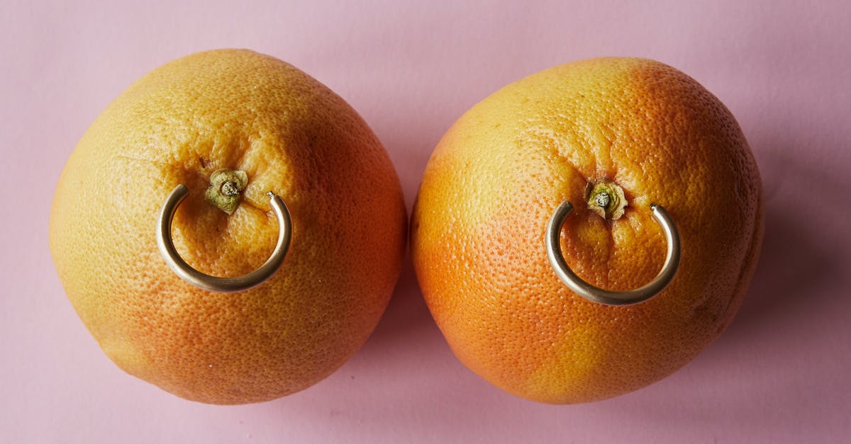 What happens to Clifford in Ad Astra? - Fresh mandarins with earrings placed on pink surface