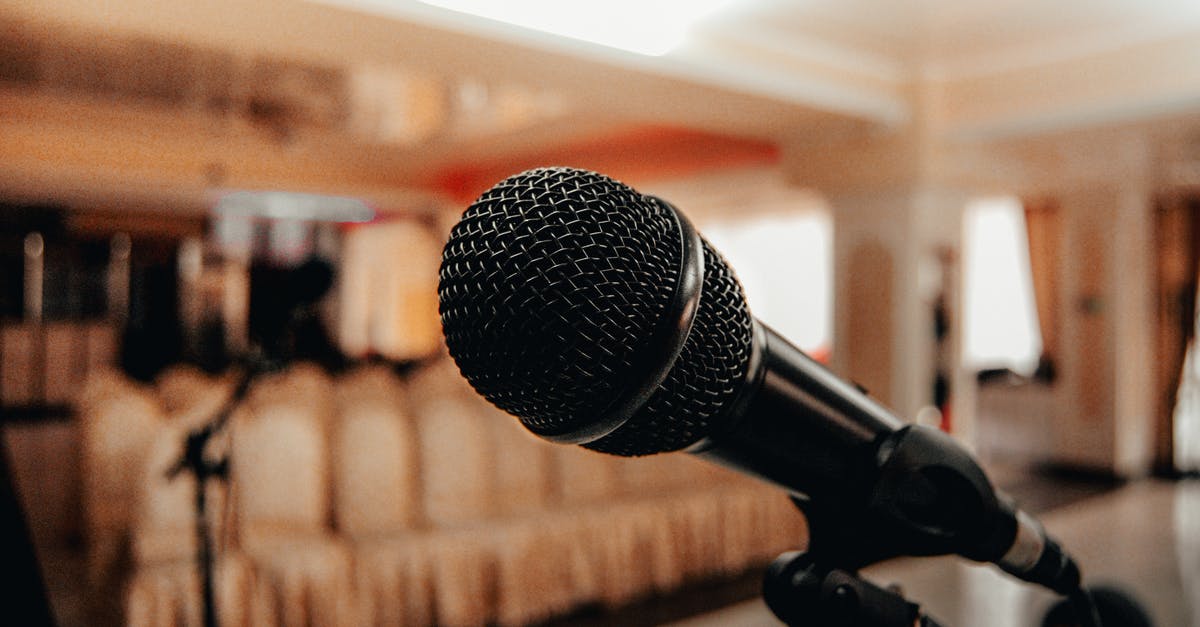 What happens to talk show giveaways that don't match the audience? - Closeup of black modern microphone on stand placed in spacious meeting room with chairs