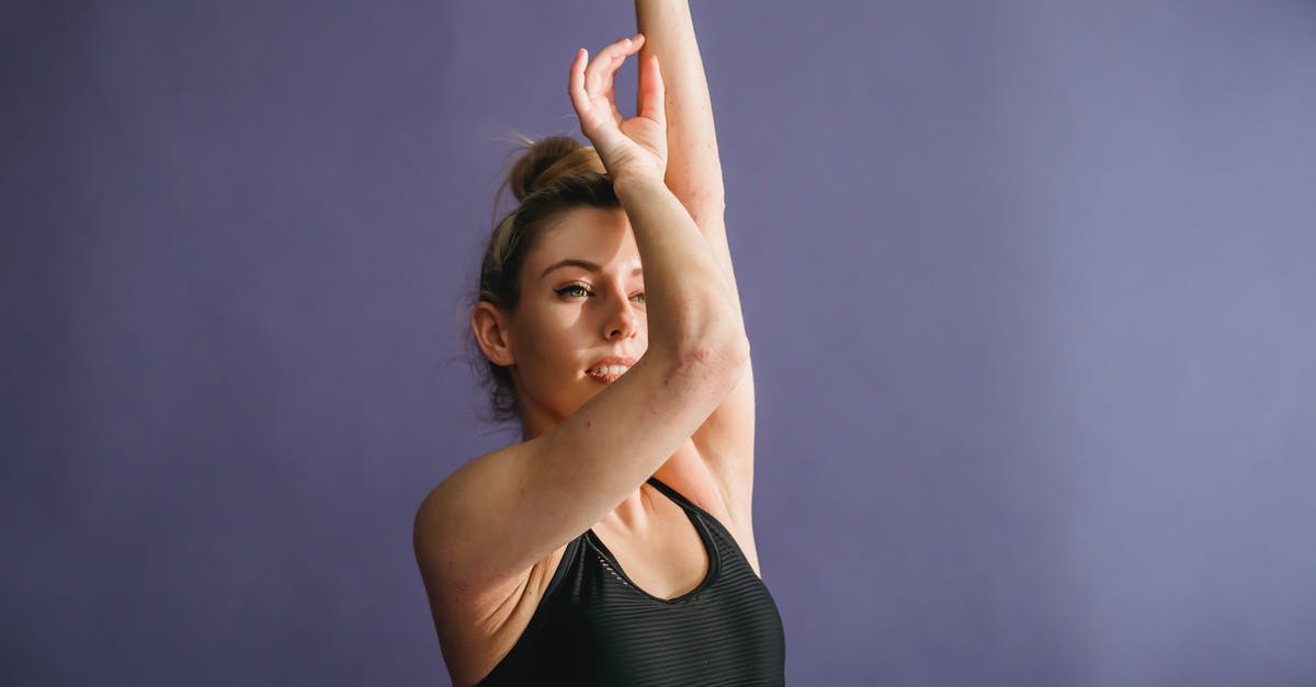 What inspired Elaine's dance moves? - Graceful woman with bun on head and arms raised dancing