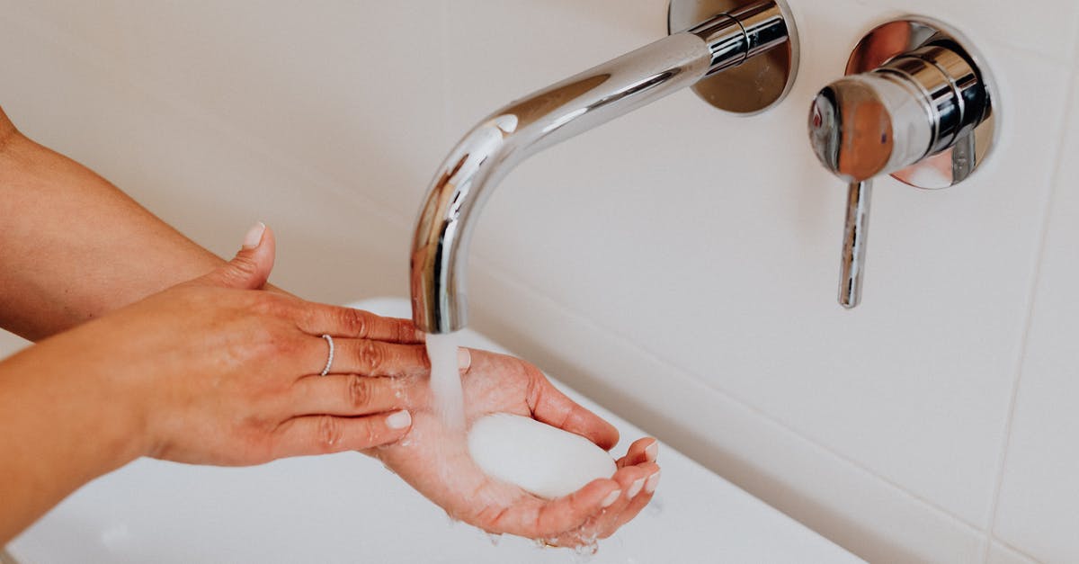 What is a "soap"? - Person Holding Stainless Steel Faucet