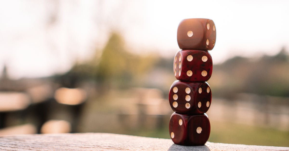What is Red's motivation? - Set of red dice stacked together on wooden table placed on sunny terrace in daylight