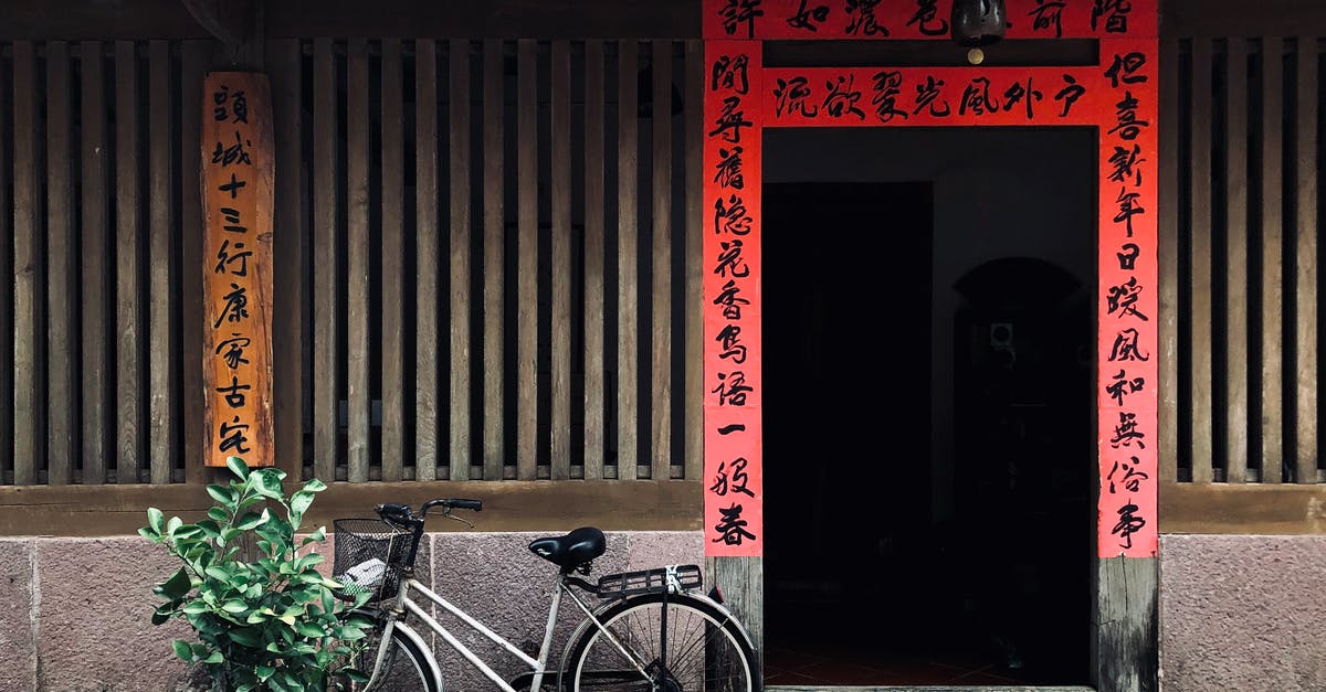 What is said on the Chinese broadcast 34 minutes into Looper? - Black City Bike Parked Beside Red Wooden Door