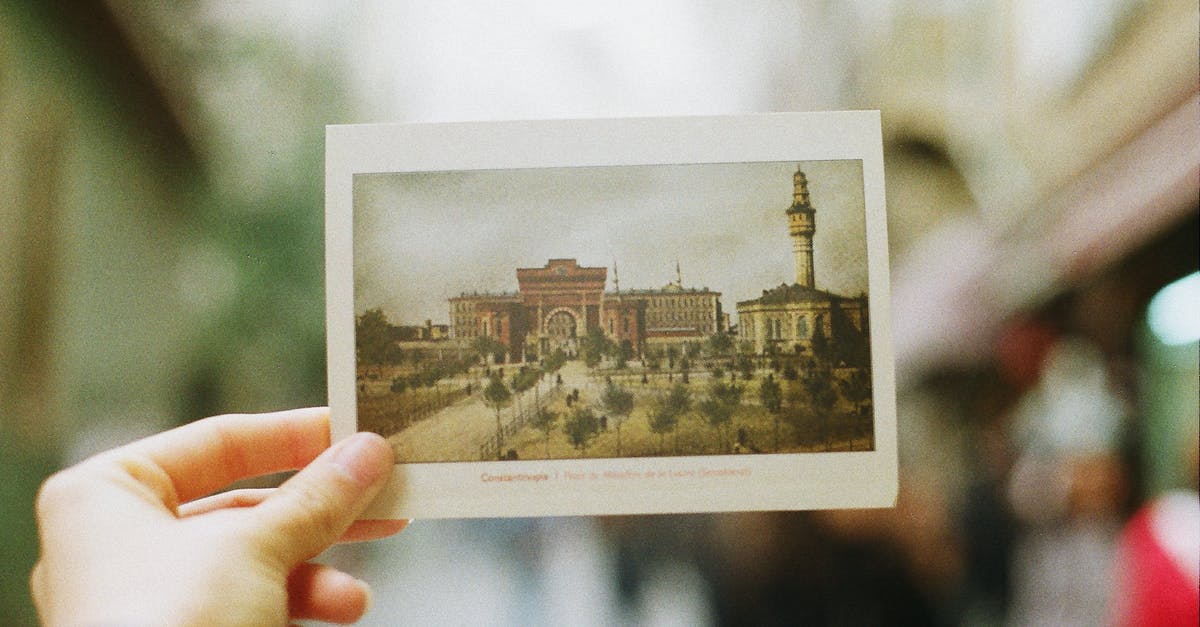 What is that tower they always show in Grey's anatomy? - Crop person showing postcard with photography of old city