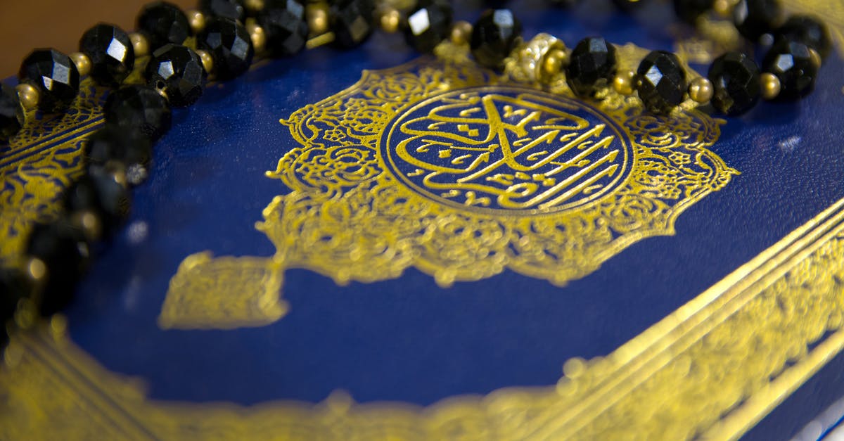 What is the Arabic saying behind “Angst essen Seele auf”? - Close-Up Shot of Prayer Beads on a Book