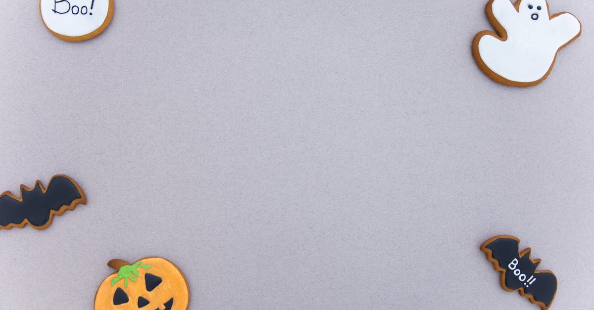 What is the difference between the horror and thriller genres? [duplicate] - Top view of assorted gingerbread cookies with icing in different Halloween decoration shapes arranged on gray surface as frame