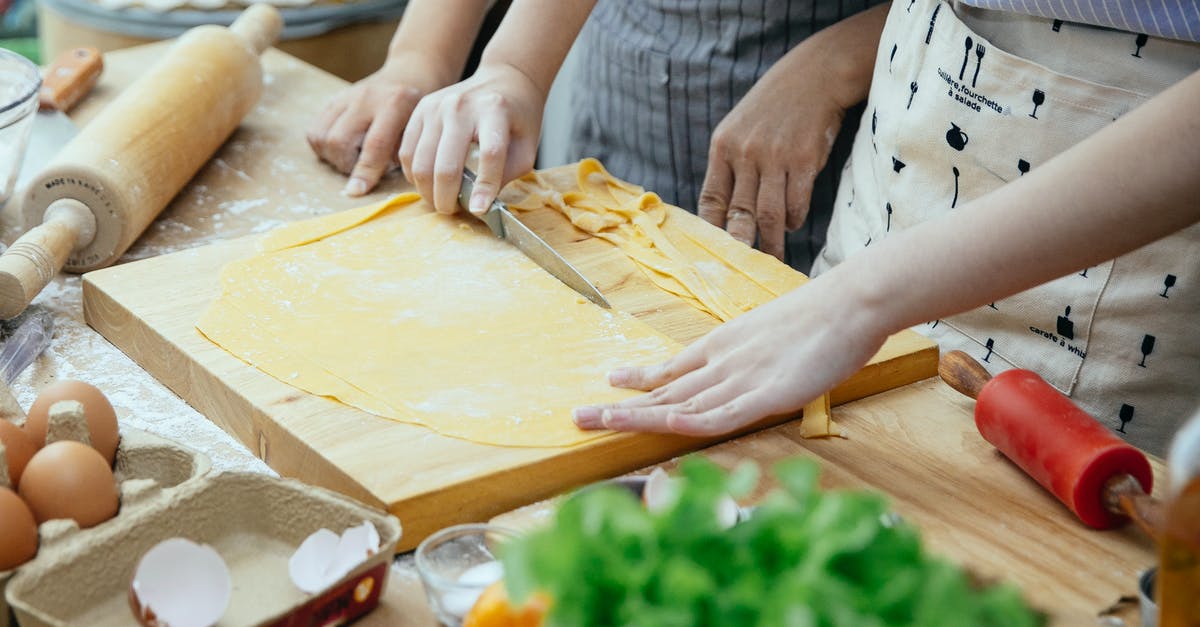 What is the meaning of "Cold Cut King of Long Island"? - Women making homemade pasta in kitchen