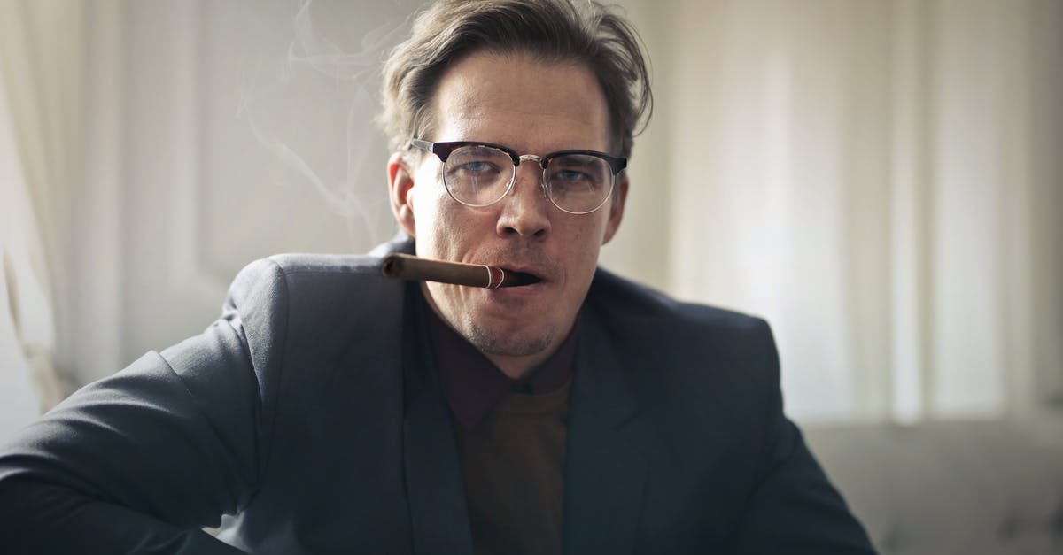 What is the meaning of the smoking hair in Yellowbeard? - Man in Black Suit Coat Wearing Eyeglasses