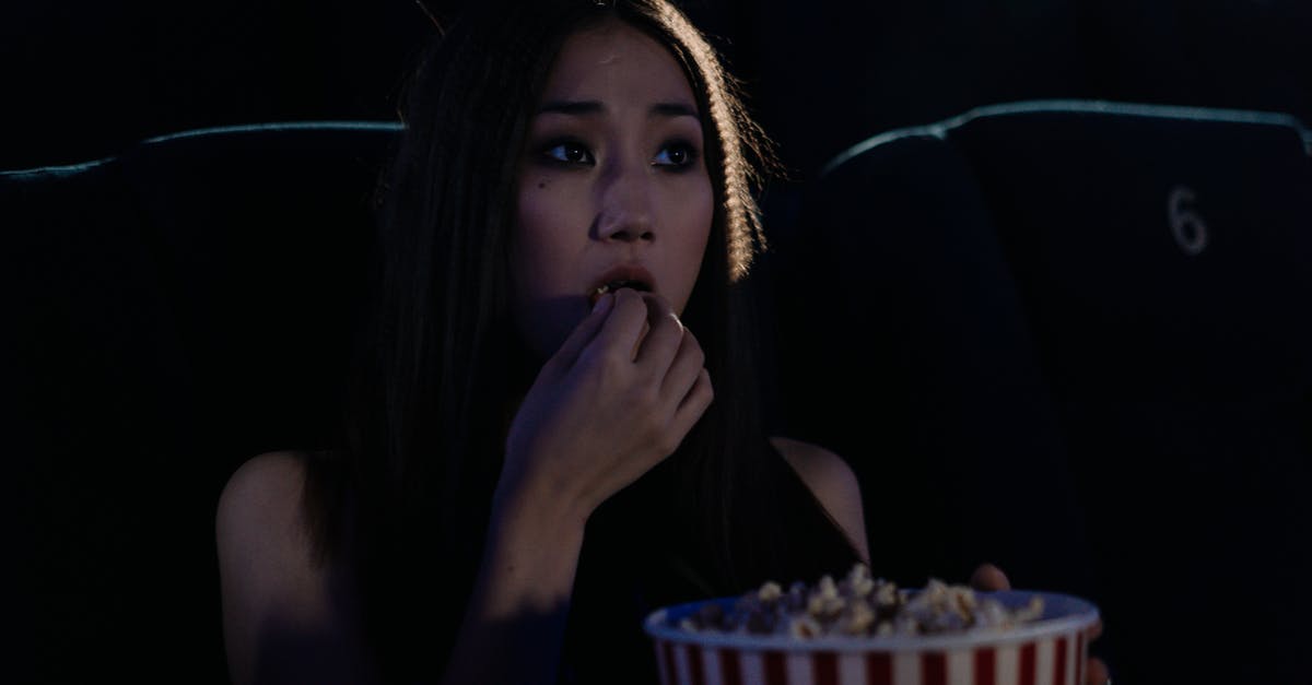 What is the name of the movie in which eating and toilet taboos are reversed [closed] - Photo of a Woman Eating Popcorn at a Movie Theater