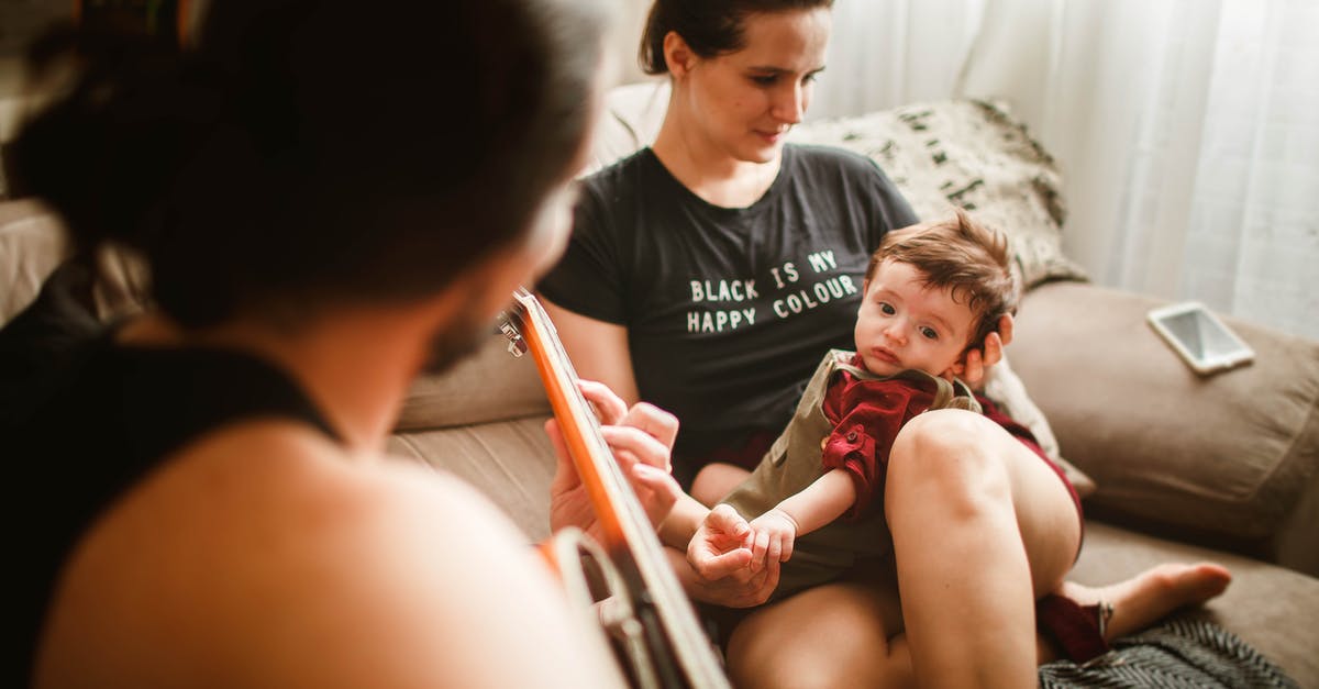 What is the name of the song that plays following "Sweetie, you and me are going to make the baby?" - Anonymous father playing guitar on couch for baby and wife