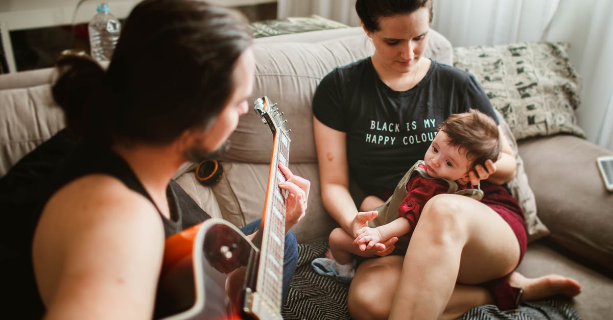 What is the name of the song that plays following "Sweetie, you and me are going to make the baby?" - Father playing guitar for mother with baby