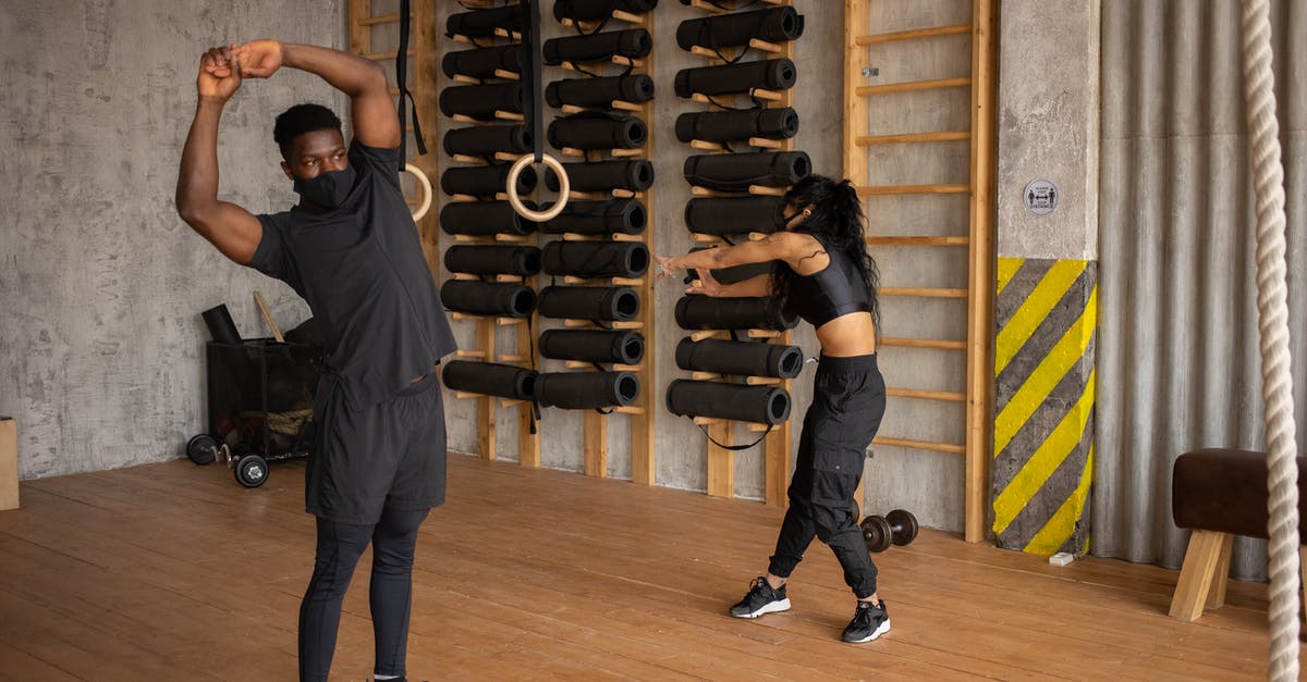 What is the name of this medical practice? - Black couple in face masks doing exercises