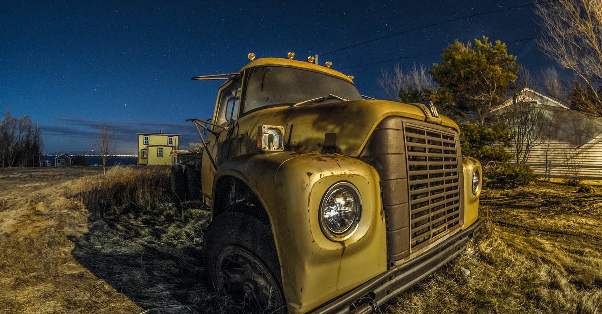What is the real vehicle used as The Highwayman's truck? - Wide angle of damaged old fashioned truck on grassy lawn in countryside under starry sky at dusk