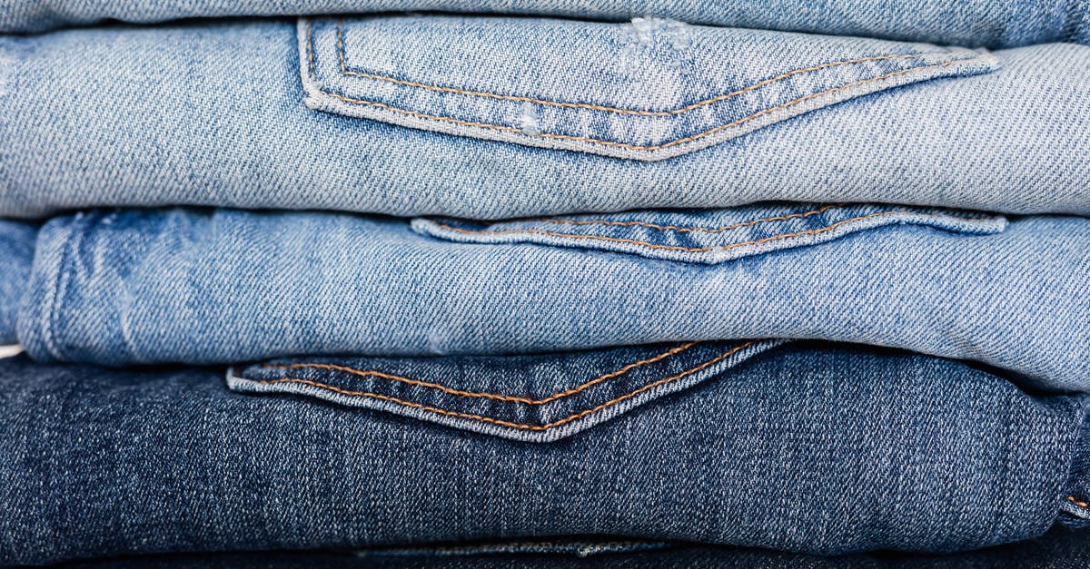 What is the reason behind choosing a different character for Legacy - Closeup of stack of blue denim pants neatly arranged according to color from lightest to darkest