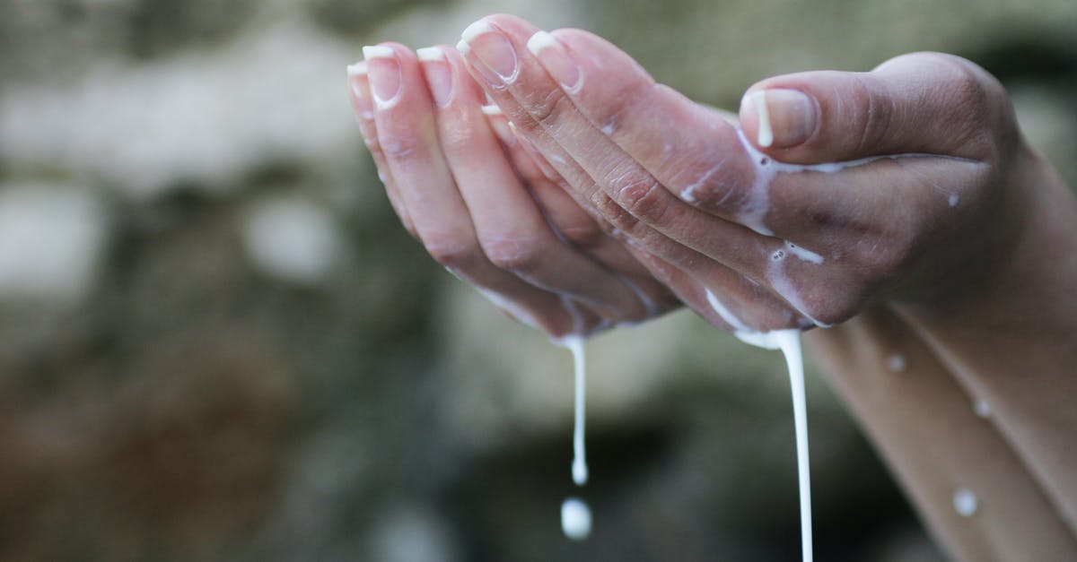 What is the relevance of the algae dripping liquid? - Person's Hands Covered in White Liquid