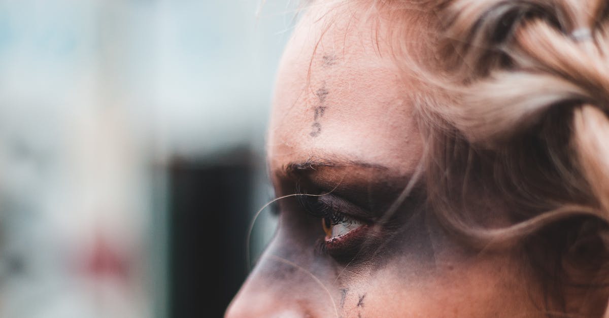 What is the secret ending of Black Mirror: Bandersnatch? - Crop side view of blond woman with black mask makeup and symbols on face looking away