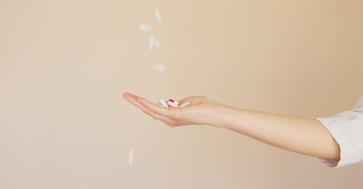 What is the significance of Lady Kaede catching and killing the insect? - Side view of crop anonymous female pharmaceutist in white coat with palm facing up catching medical capsules falling down from above on light brown background