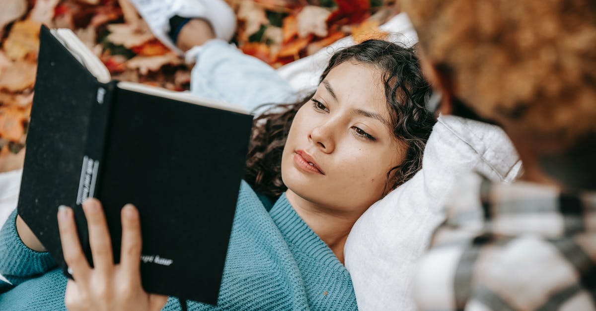What is the significance of "6,741", the title of an upcoming episode in the fifth season of Person of Interest? - From above of pensive Hispanic female reading book while lying on lap of crop person while spending free time together in autumn nature