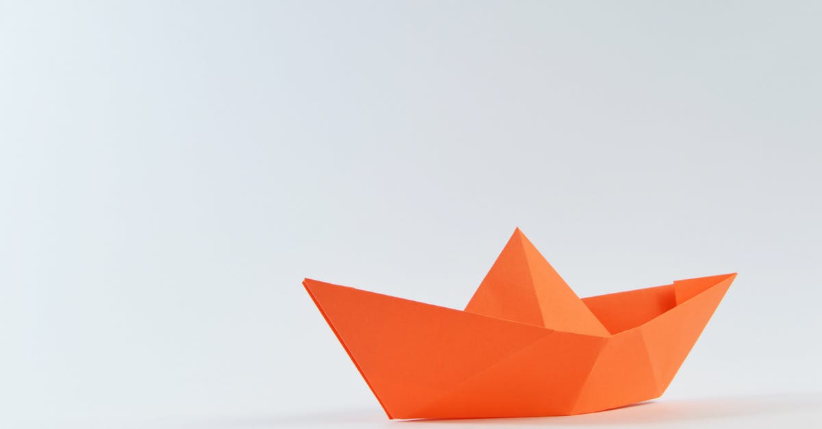 What is the significance of the Origami Bum? - Orange Paper Boat on White Surface