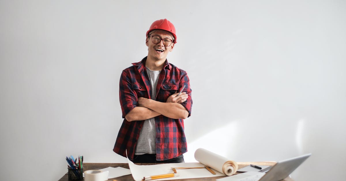What is the supervisor girl doing in TV show 3%? - Smiling casual man in hardhat and glasses holding arms crossed looking at camera while standing at desk with paper draft and stationery