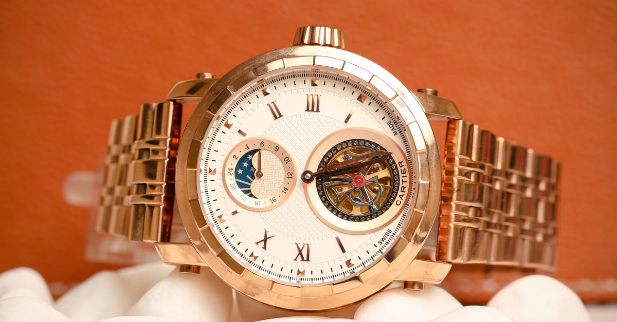 What is the symbolism of the gold watch? - Cartier Brand Watch with Astrological Symbols and Copper Gold Bracelet