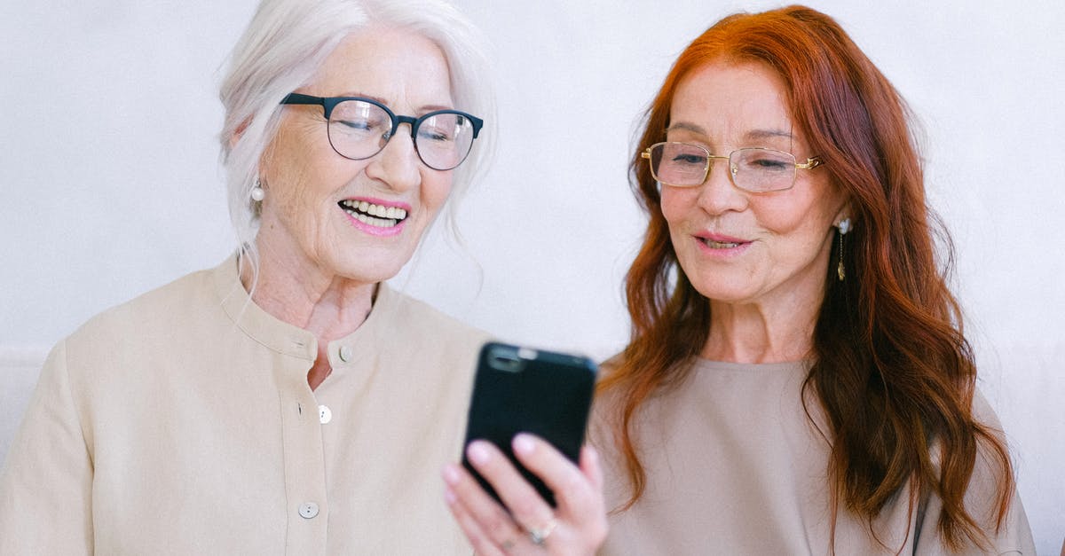 What is the term for video quality that is intentionally made to look old or degraded? - Cheerful aged women smiling and watching video online on smartphone