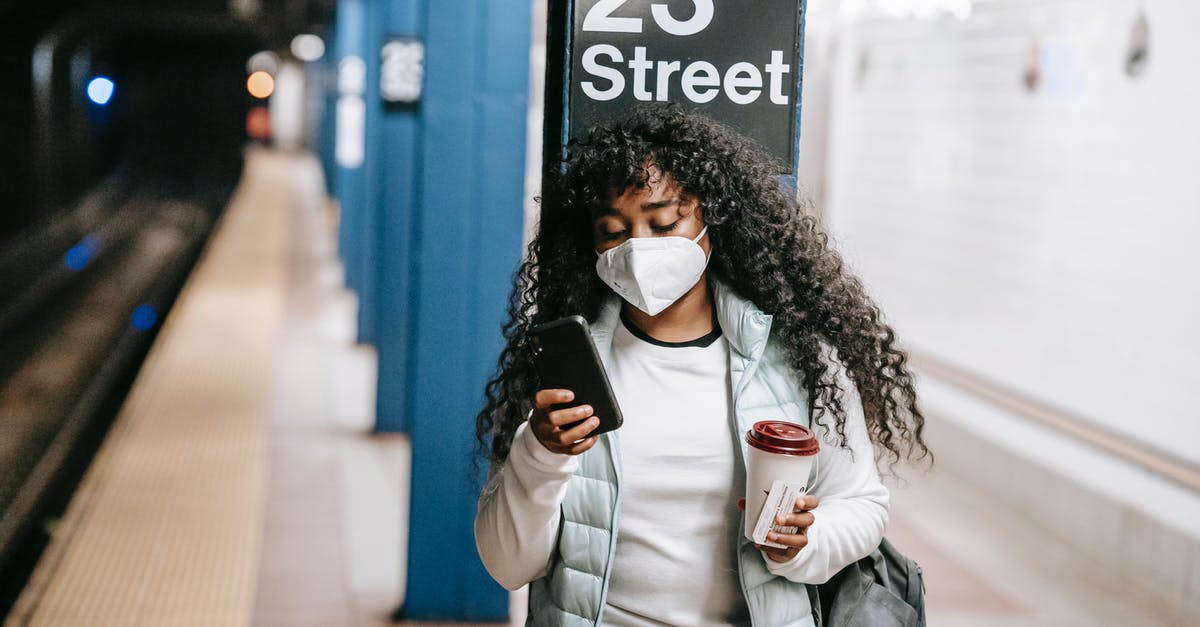 What is the worst month to watch movies in United States? - Focused black woman using smartphone on metro platform