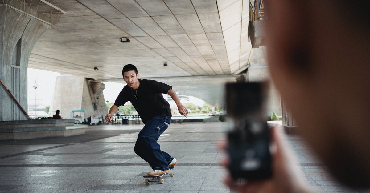 What is this kind of stunt called and what is the highest record for it [closed] - Full body of sportive man riding on skateboard under bridge and looking at camera of smartphone during training in street