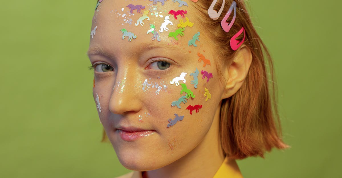 What is this shining look like effect called? - Crop woman with multicolored stickers on face in photo studio