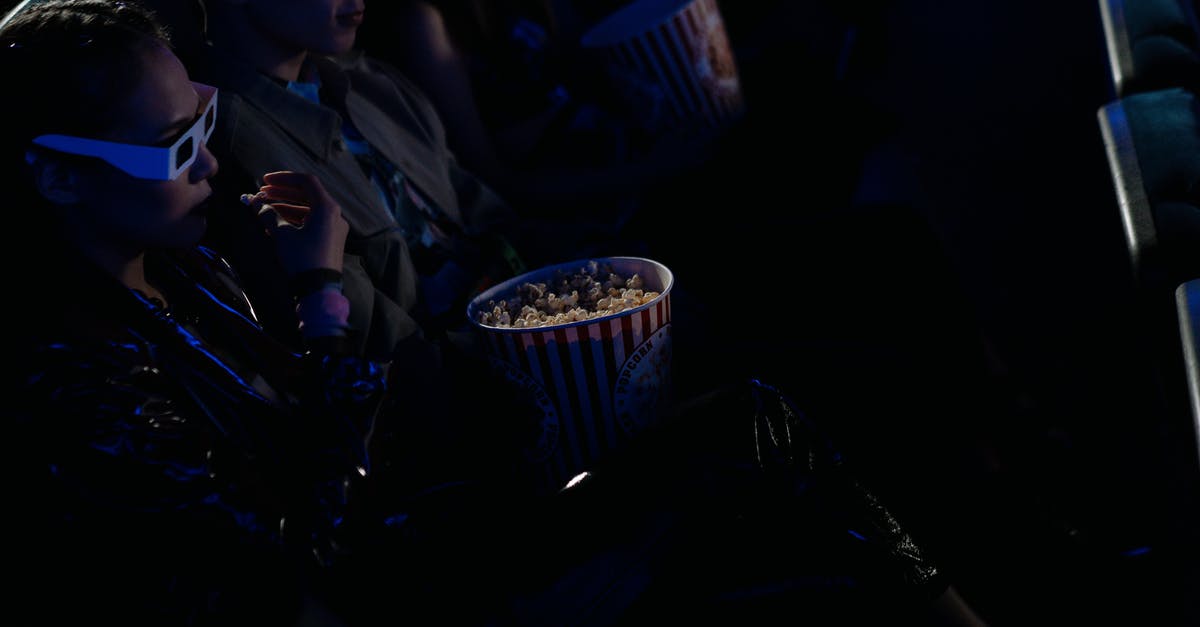 What movie is Don watching? - Man in Black Suit Jacket Holding Cup