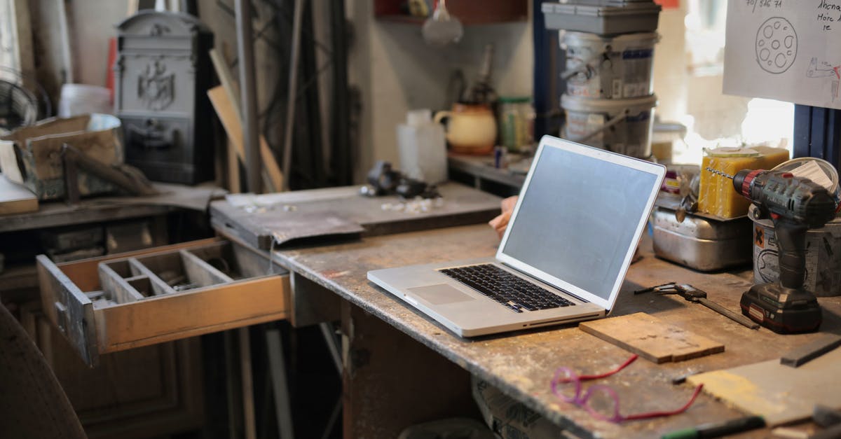 What process does a production company have to go through in order to obtain a 'high profile' actor/actress? - From above of modern laptop laying at table among different tools and equipment in workshop
