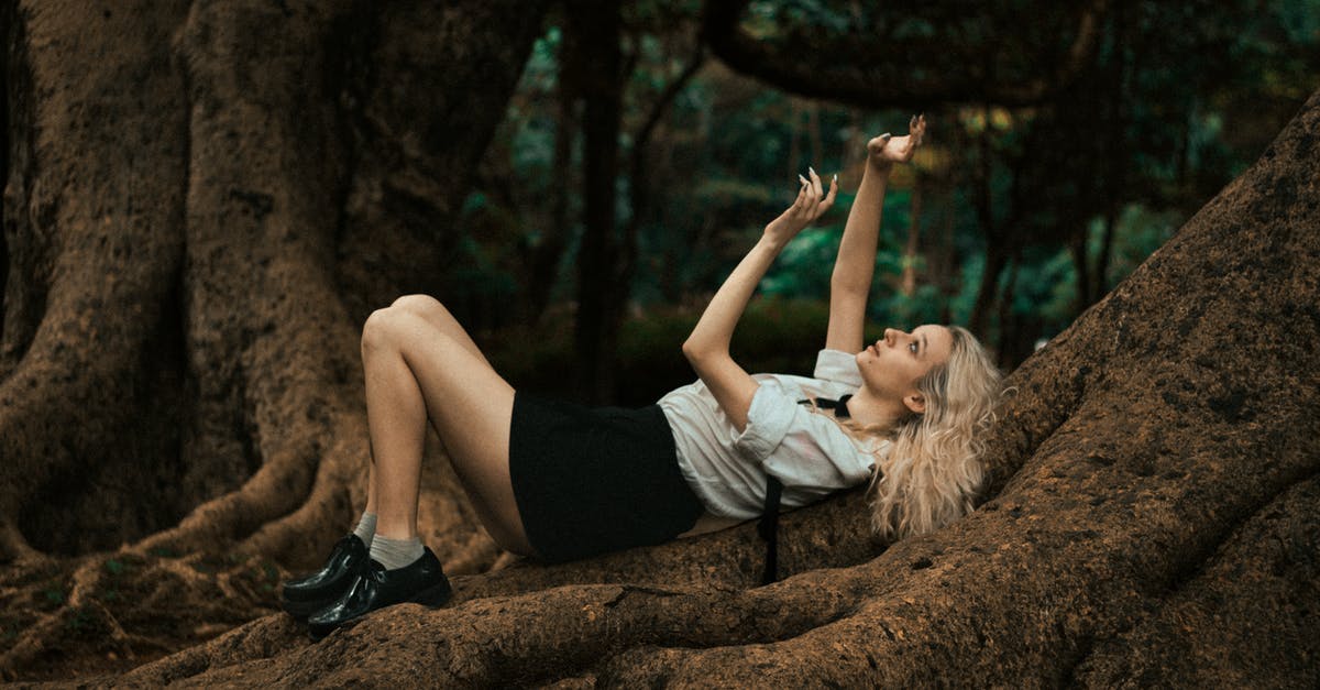 What role Bob Anderson did play, Imperial or Rebel? - Blonde Woman Lying on Massive Forest Tree Roots and Gesturing