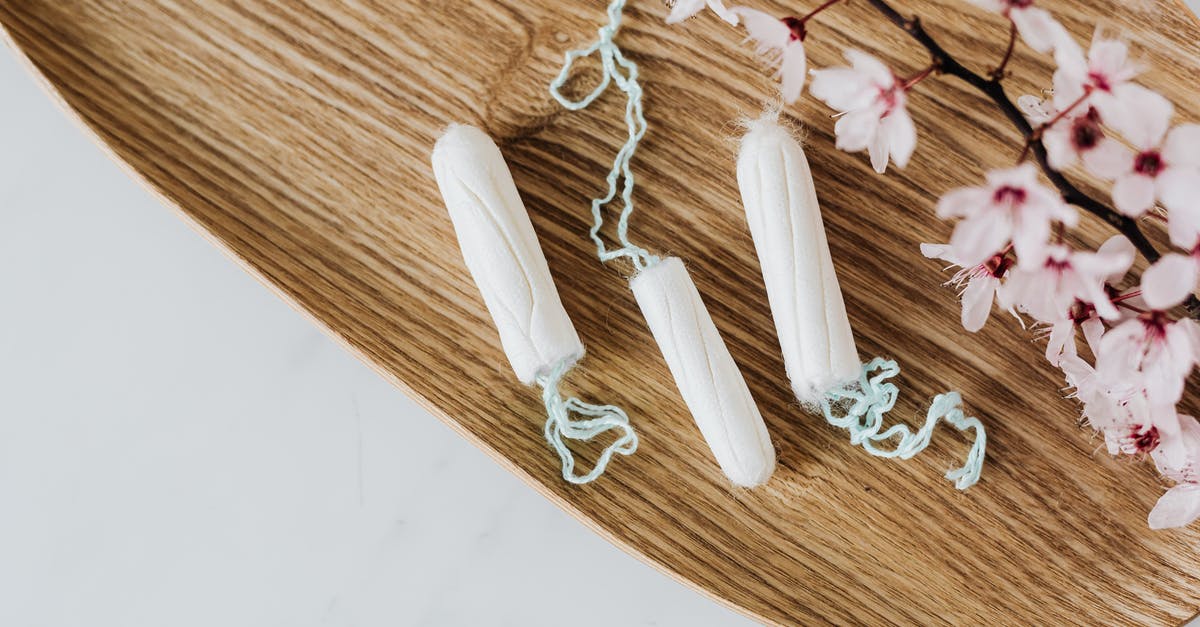 What time period is Pennyworth set in? - From above of hygienic cotton tampons placed on bamboo board with small pink flowers