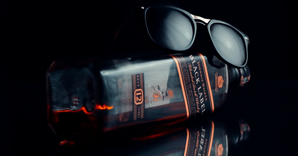 What was the brand of whisky that Rossi received? - Black Framed Eyeglasses on Black Surface