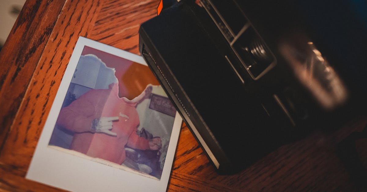 What was the first film shot completely with a subjective point of view? - Top view of instant old fashioned camera placed on wooden table near torn picture
