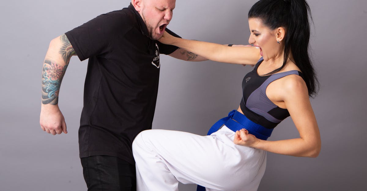 What was the first martial arts movie where someone plucked out an eye? - Strong sportswoman with partner performing self defense technique during combat