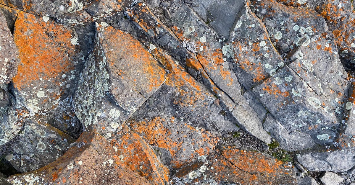 What was the galaxy formation Rust saw before confronting Erol Childress? - Top view of rough natural rock surface with cracks and orange rust as abstract  background