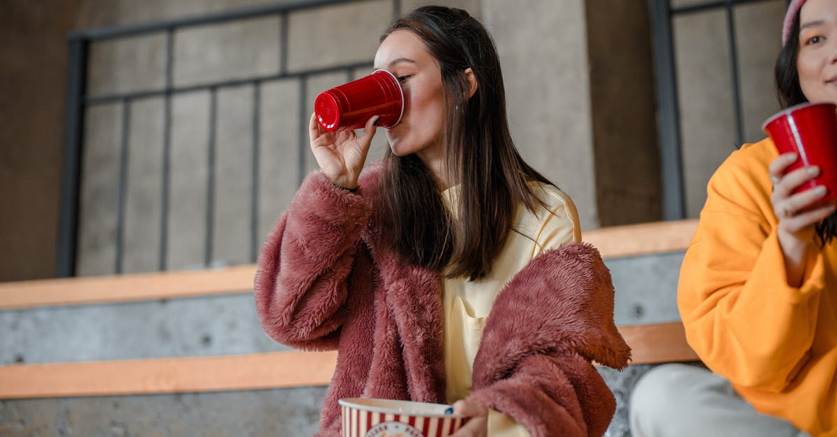 What was the point of eating and drinking? - Woman in Brown Coat Drinking from Red Ceramic Mug