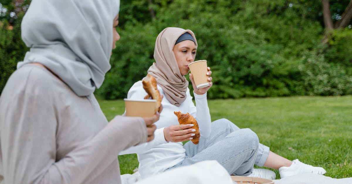 What was the point of eating and drinking? - Woman in White Hijab Sitting on Brown Wooden Bench