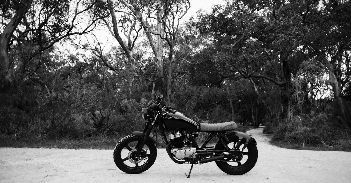 What was the purpose behind the metal object Forest Whitaker rubbed on Jake Gyllenhaal's face in Southpaw? - Black and white of metal motorcycle parked on sandy road near forest with deciduous trees and lush bushes