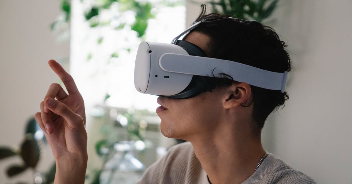 What was the virtual reality research that was used to produce the movie A.I.? - Side view of concentrated young guy in casual clothes experiencing virtual reality in modern headset at home