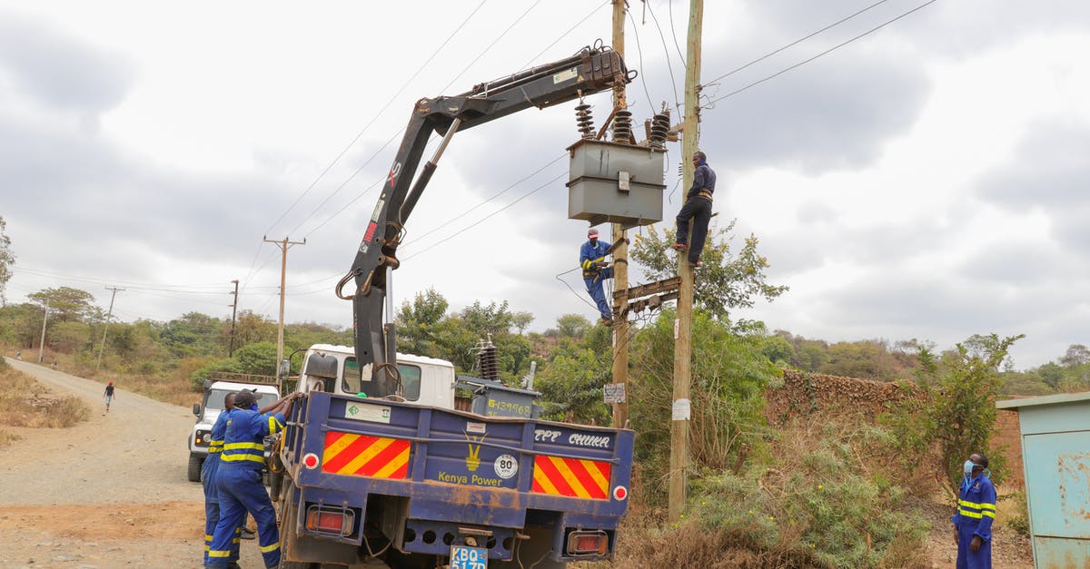 What was Thor-2014 doing when current Thor on Asgard? - Men Working and Fixing an Electricity Pole 