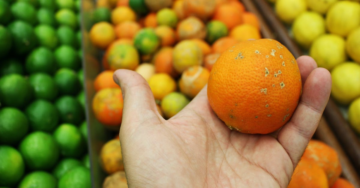 What was with the rotten fruits? - Orange Fruit on Persons Hand