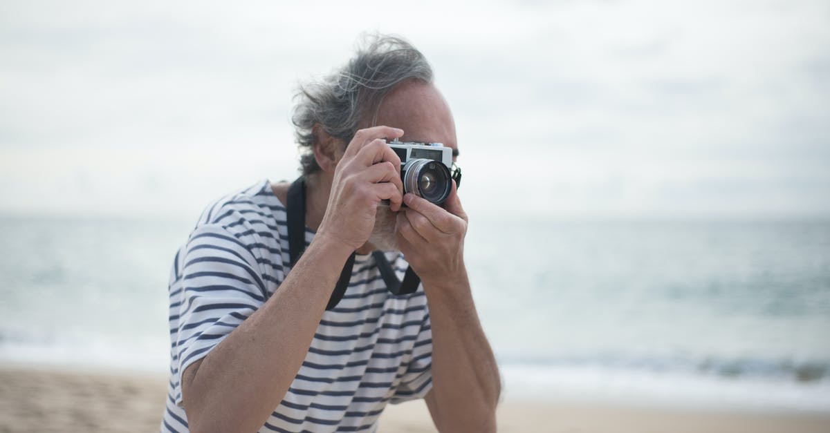 What were the first 18 photos Debbie Ocean sent to John Frazier? - Free stock photo of beach, binoculars, elderly