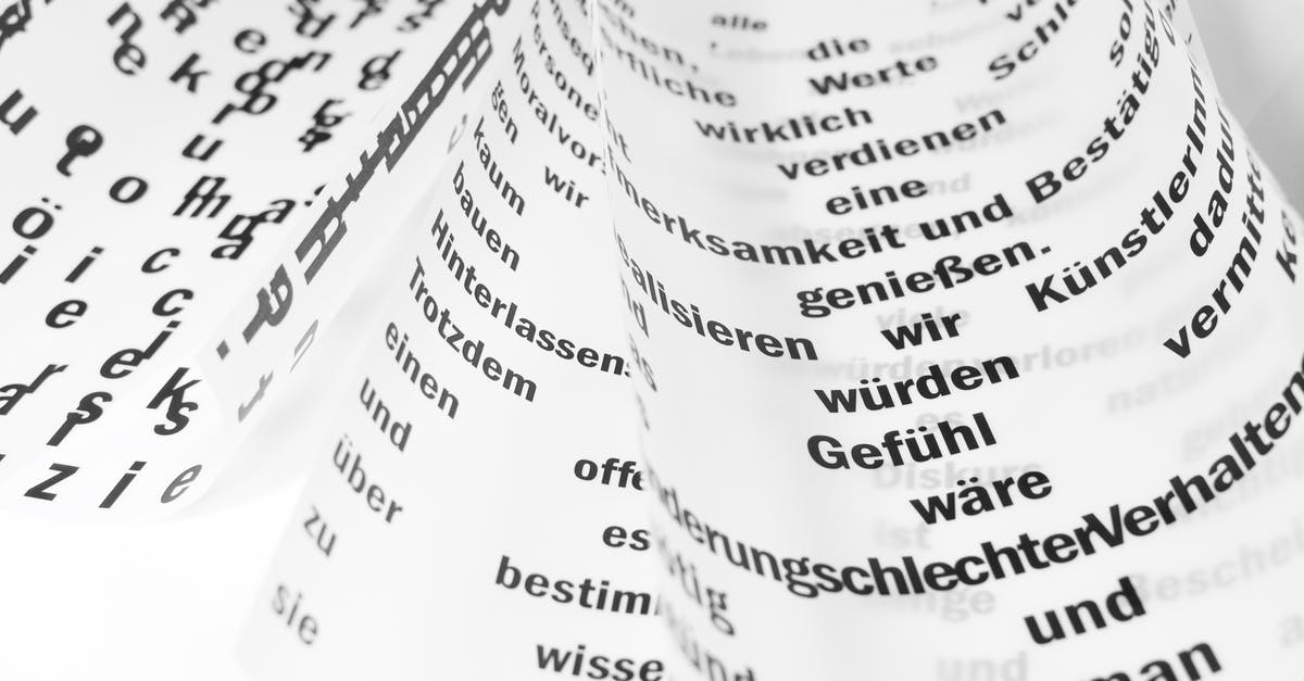 What were the German words spoken by Stormfront? - From above of white sheets of paper with curled edges and black written words placed on white background in light room