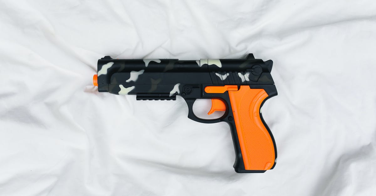 What will be the next weapon of Thor? - Black and Orange Semi Automatic Pistol on White Textile