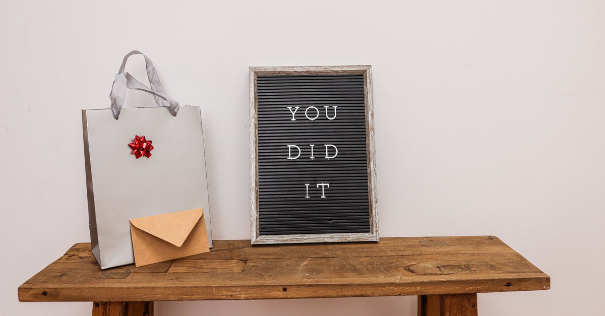 When did they become invisible? - A Letter Board Beside a Present and Envelope on a Wooden Table