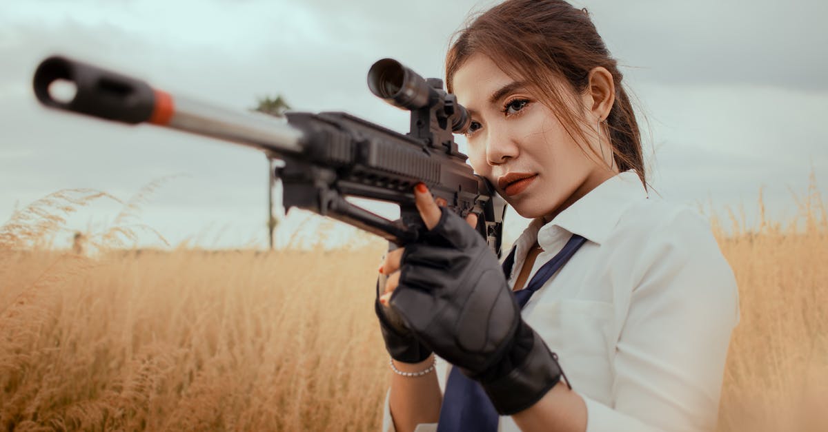When Jesse was imprisoned, it does not look like he considered using the dangerous chemicals he had access to as a weapon - Serious Asian woman with rifle on grassy field