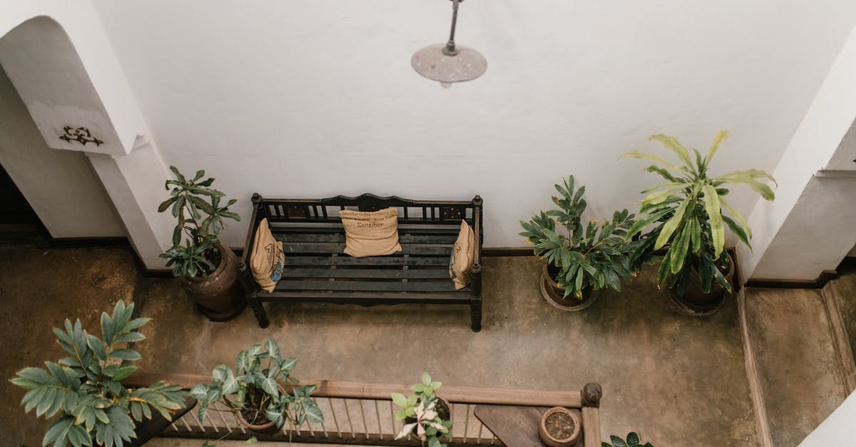Where did all the furniture that was in the villa come from? - Terrace with wooden bench and potted flowers