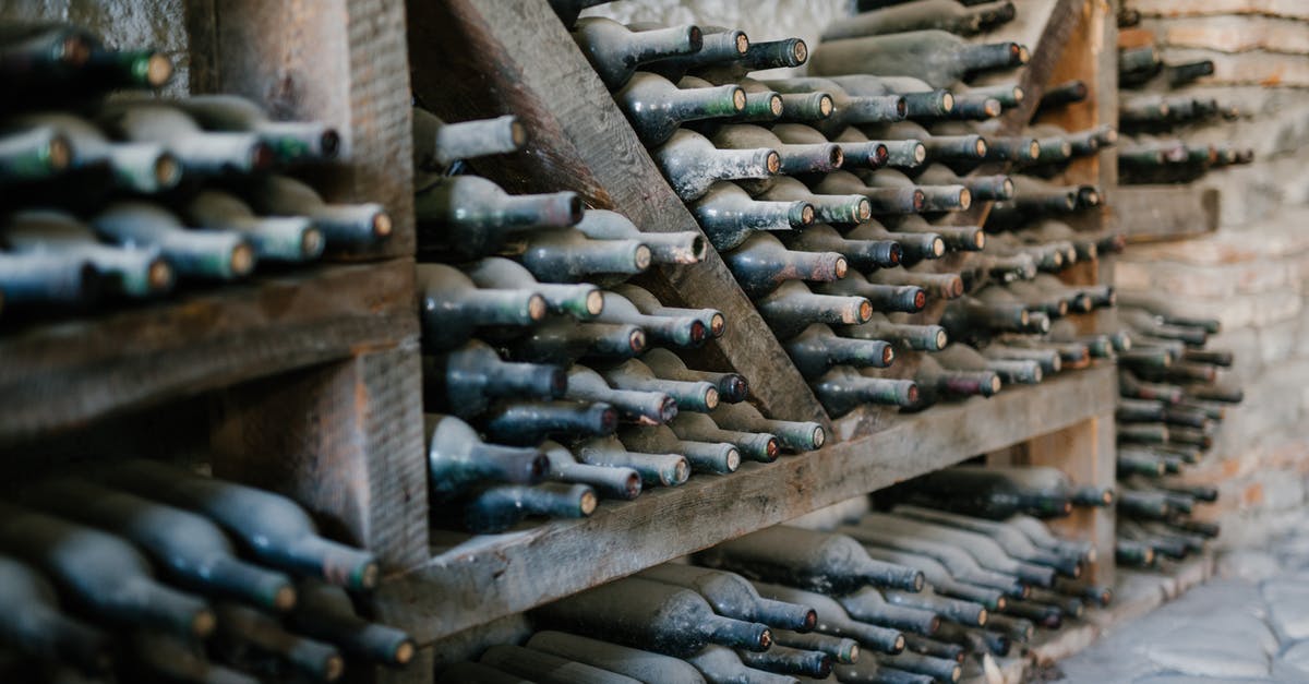 Where did the story-line of Warehouse 13 and The Librarians originate? - Dusty alcoholic beverage bottles with coiled corks on wooden shelves at wine farm