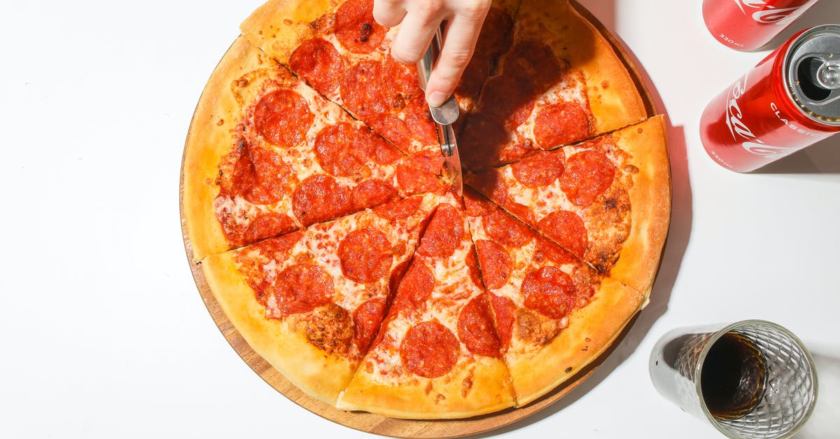 Where Does The Meat Come From - Person Slicing A Pizza With A Pizza Cutter